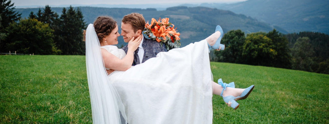 Charlyn wears Hetty Mid Blue Blossom Small Rose Gold